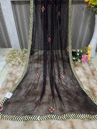 Chic Black Georgette Saree with Red Accents & Golden Chevron Border