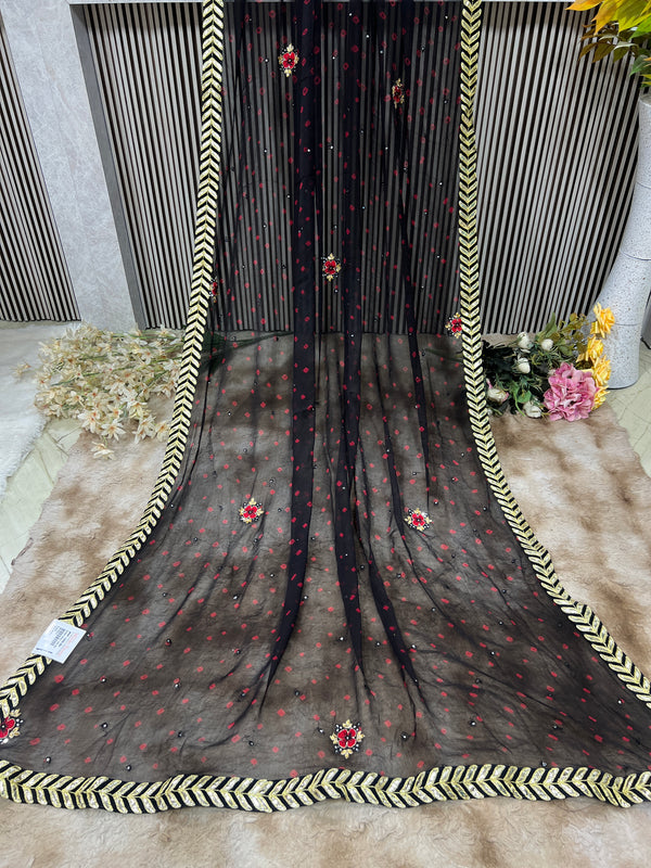Chic Black Georgette Saree with Red Accents & Golden Chevron Border
