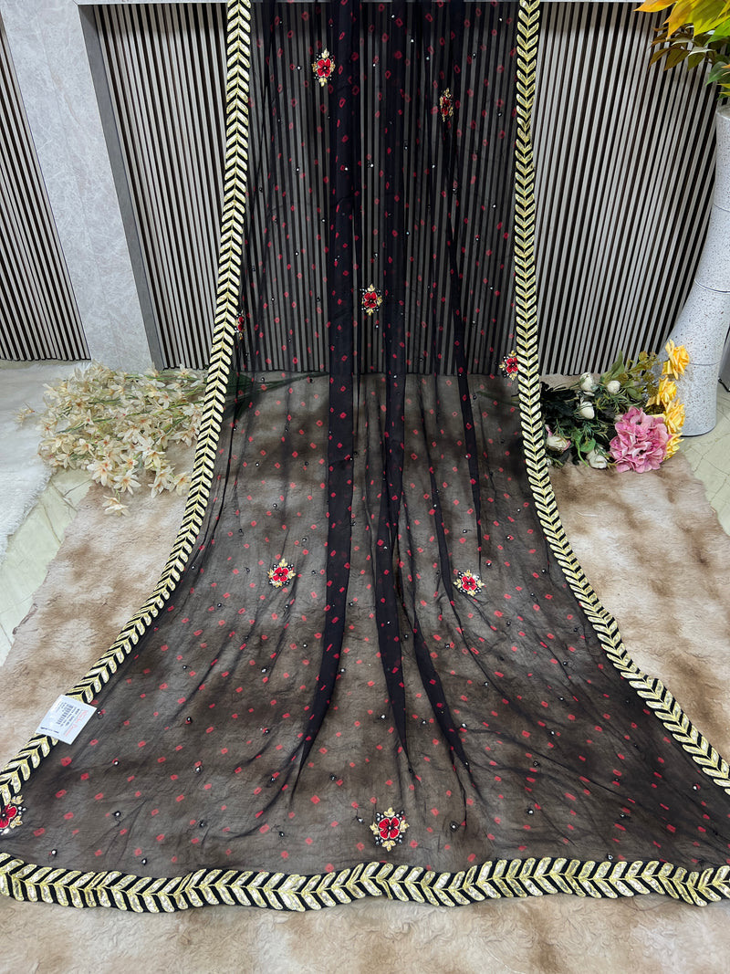 Chic Black Georgette Saree with Red Accents & Golden Chevron Border