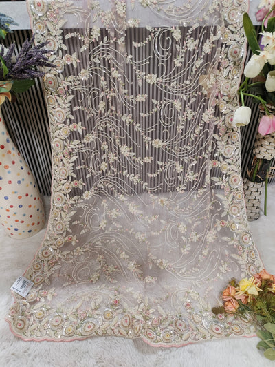 Enchanting Pastel Peach Floral Net Saree with Shimmering Sequin Detail