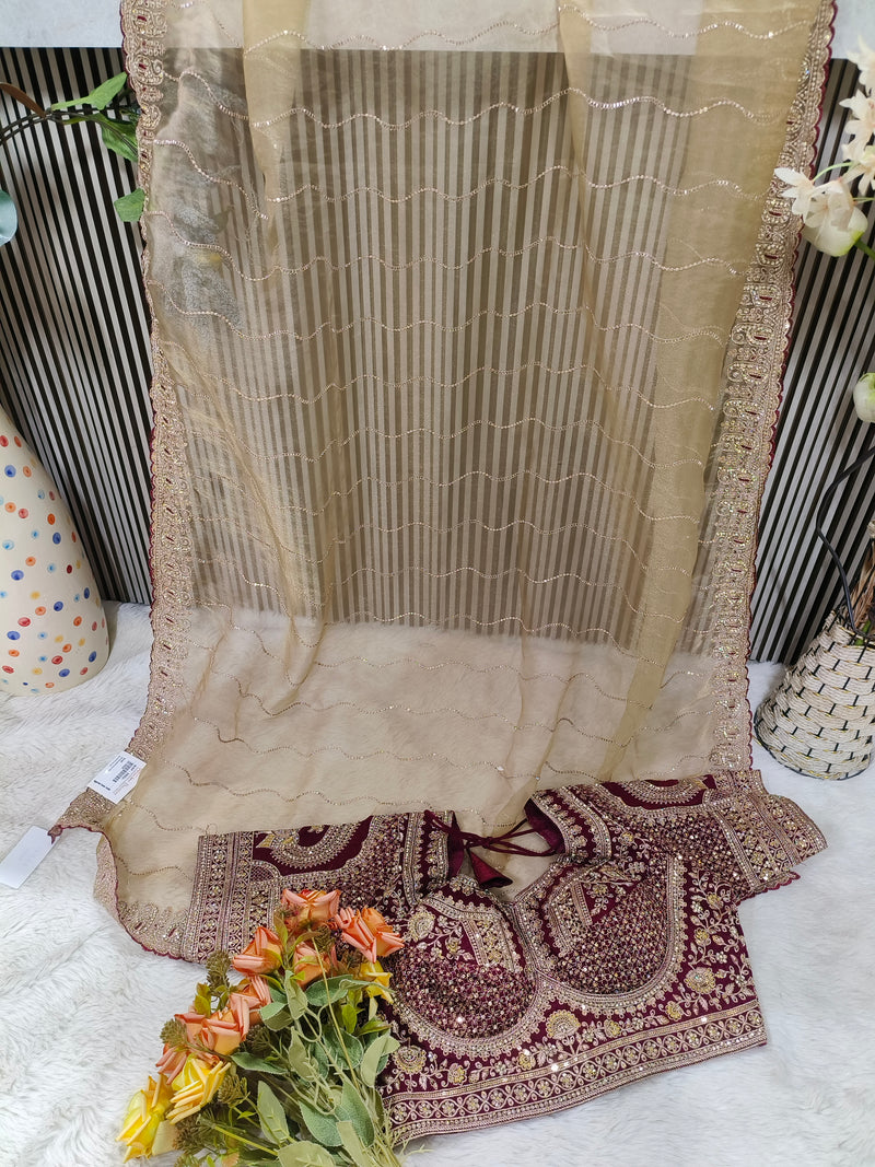 Glamorous Rose Dust Net Saree with Heavily Embroidered Wine Blouse