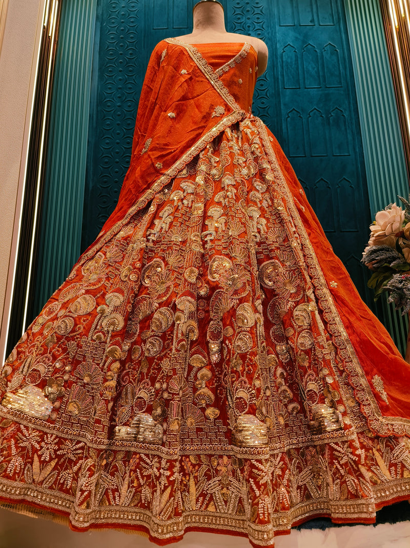 Classic Amber-Orange Bridal Lehenga with Intricate Traditional Motifs